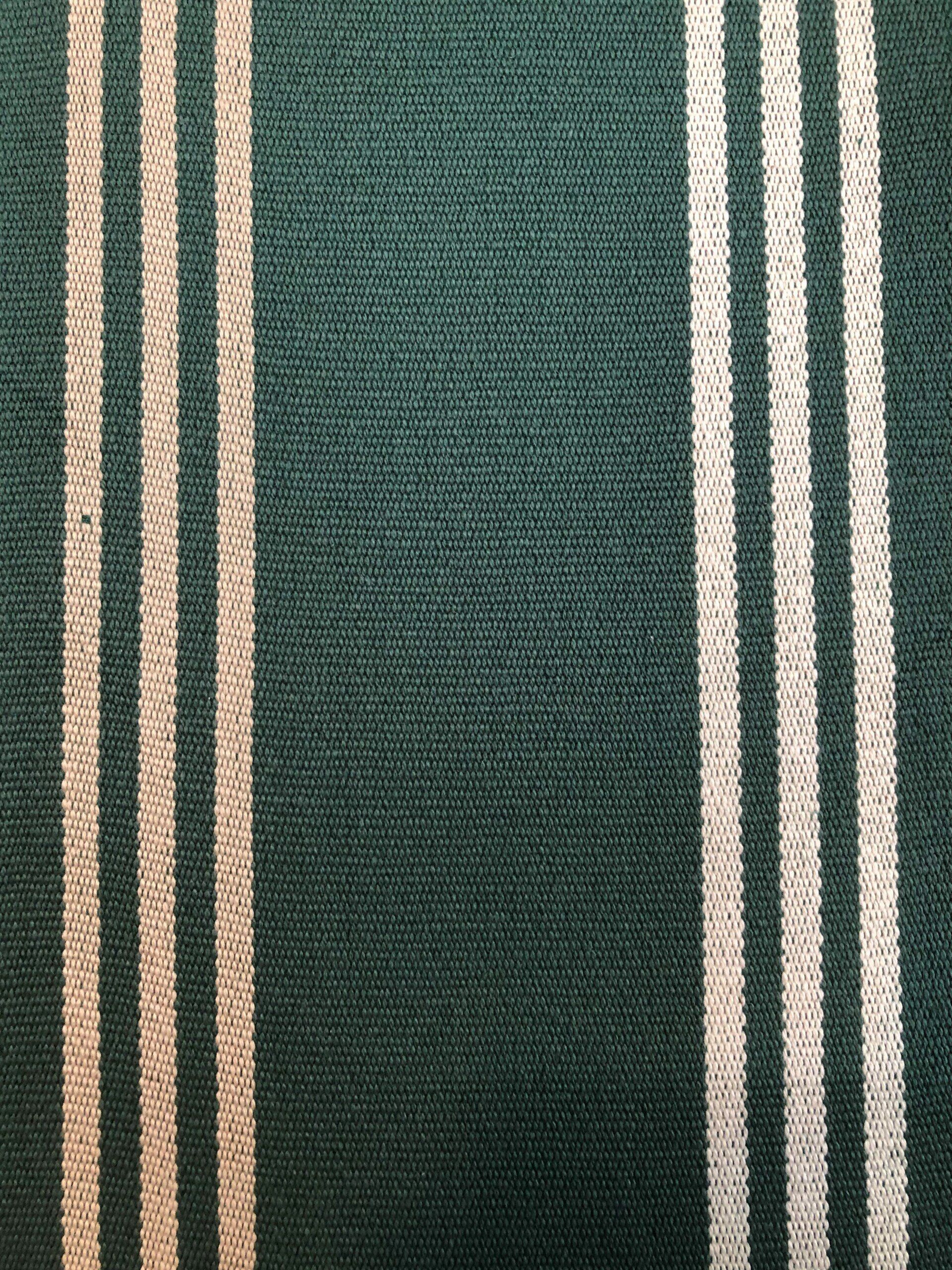 Dark green fabric with vertical white stripes.