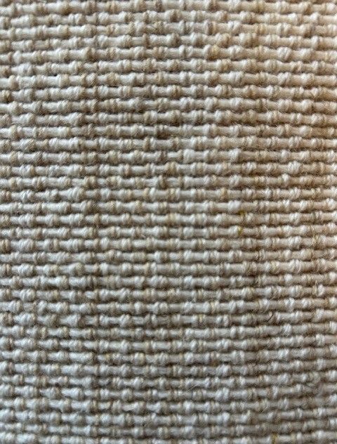 Close-up of beige woven fabric with a textured, horizontal pattern.
