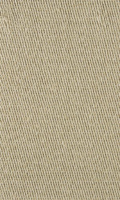 Close-up of beige fabric with a diagonal weave texture.