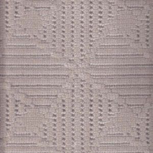 Textured, patterned fabric with geometric and floral designs in a light color.