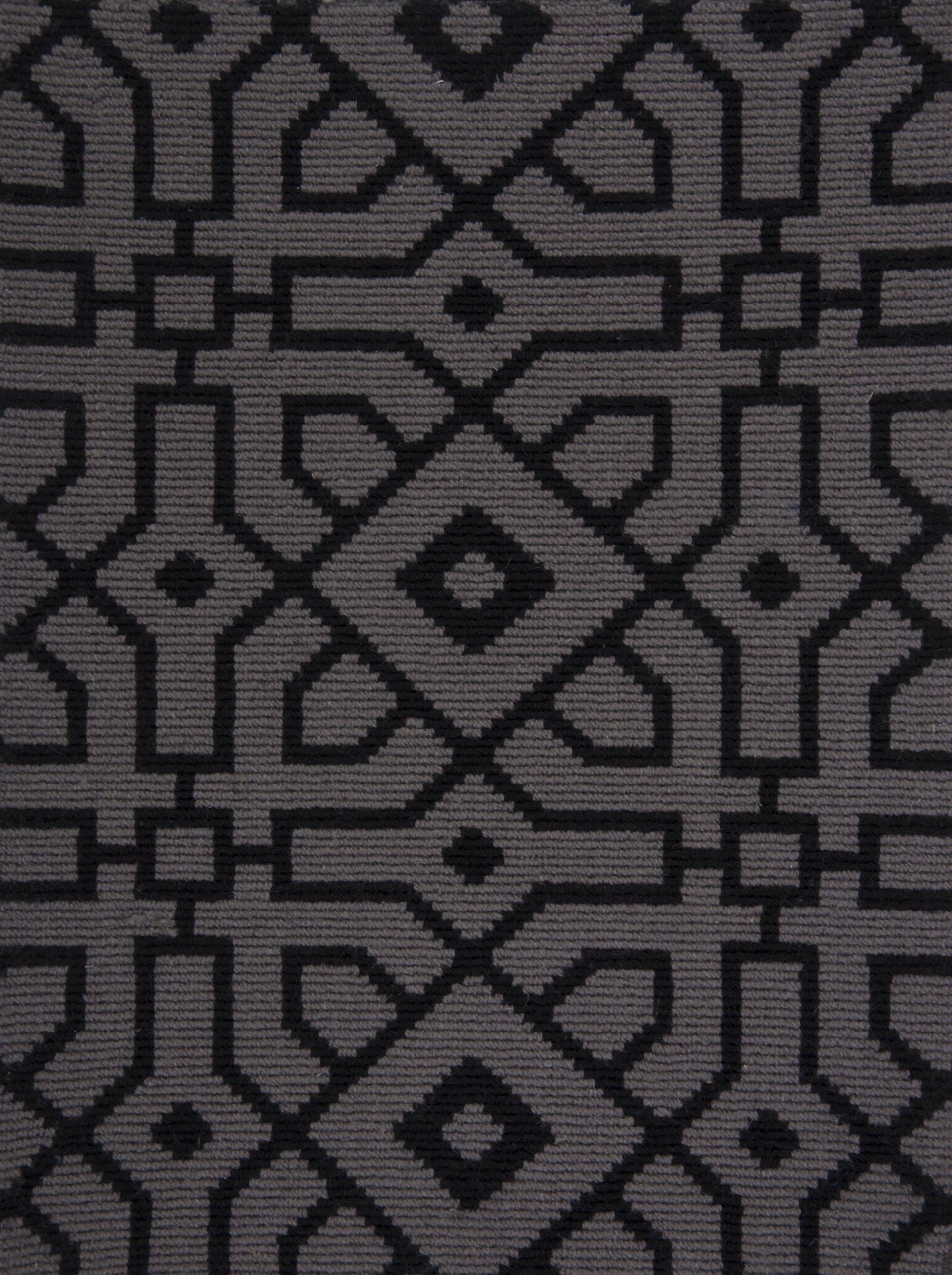 Geometric patterned fabric in dark gray and black.