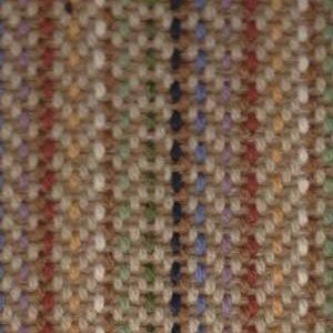 Close-up of tan tweed fabric with interwoven multicolored flecks, and vertical stripes in blue, green, and black.