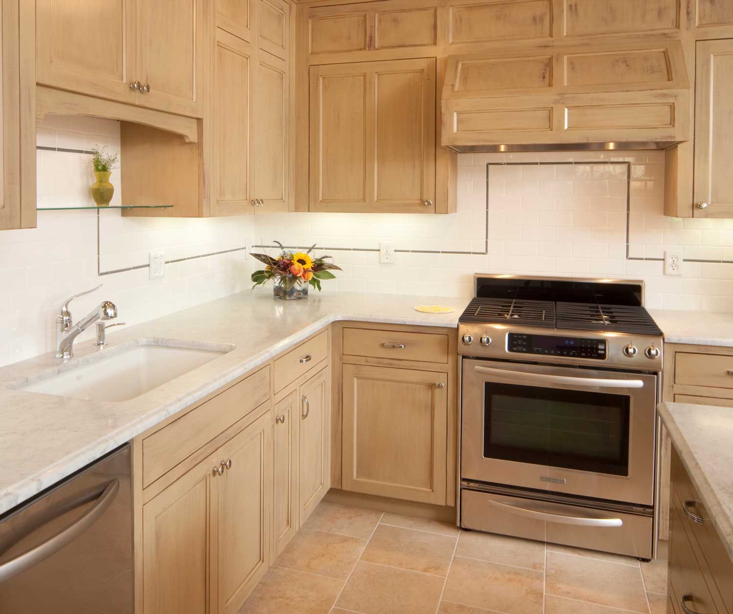 A kitchen with stainless steel appliances and wooden cabinets