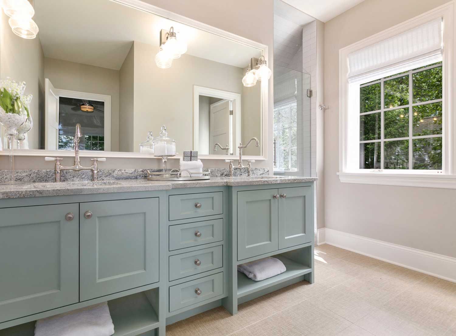 A bathroom with two sinks and a large mirror.