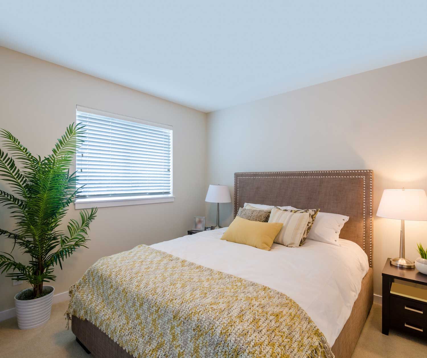 A bedroom with a large bed and a window