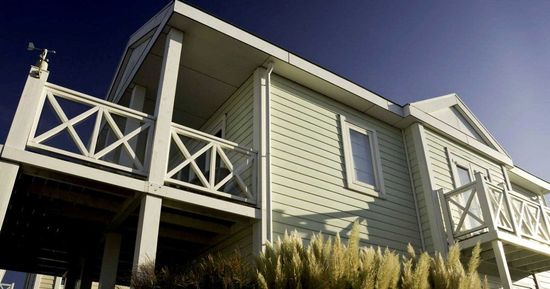 An empty living room with hardwood floors and painted walls.