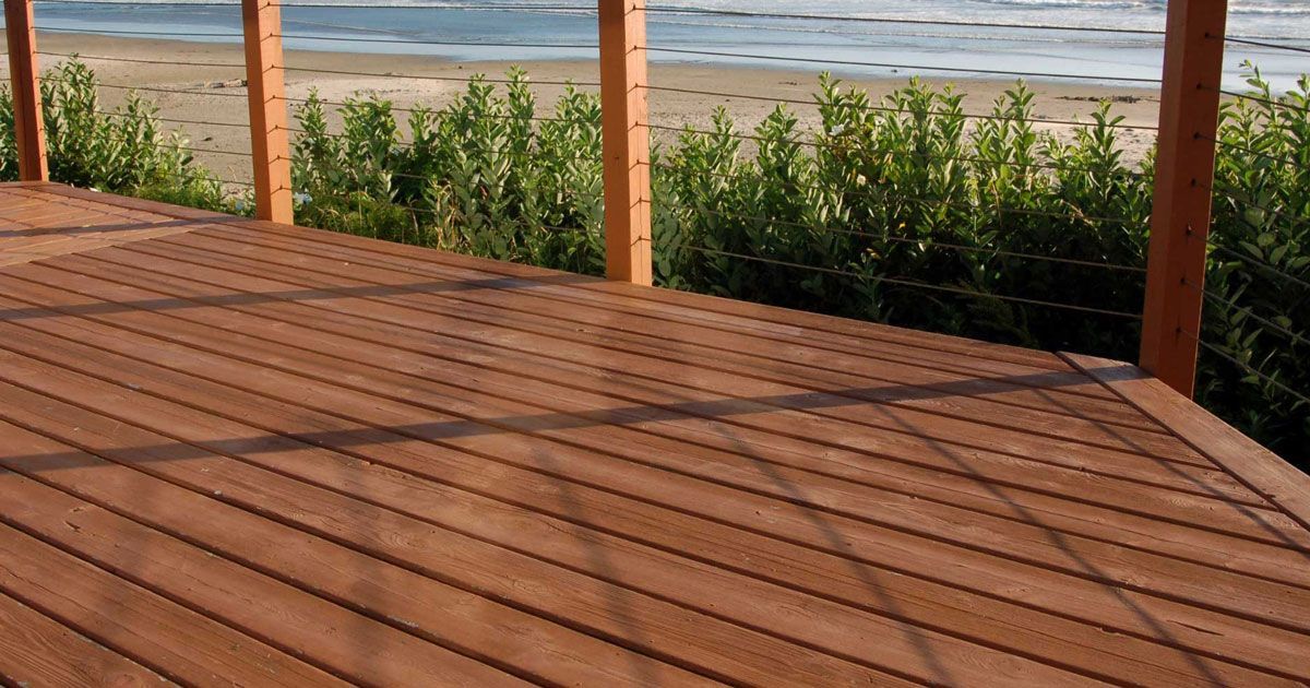 A bathroom with a toilet , sink , mirror and shower.