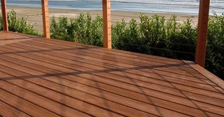 A bathroom with a toilet , sink , mirror and shower.
