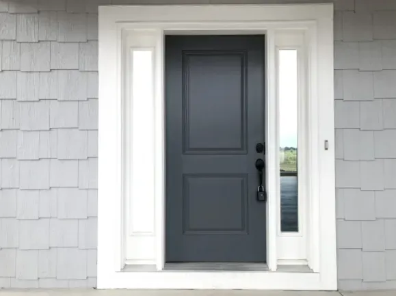 The front door of a house with a black door and white trim.
