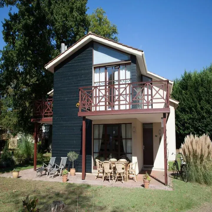 A house with a balcony and a table and chairs on it