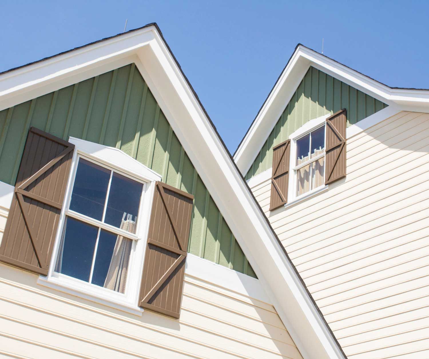 A house with a balcony and a table and chairs on it