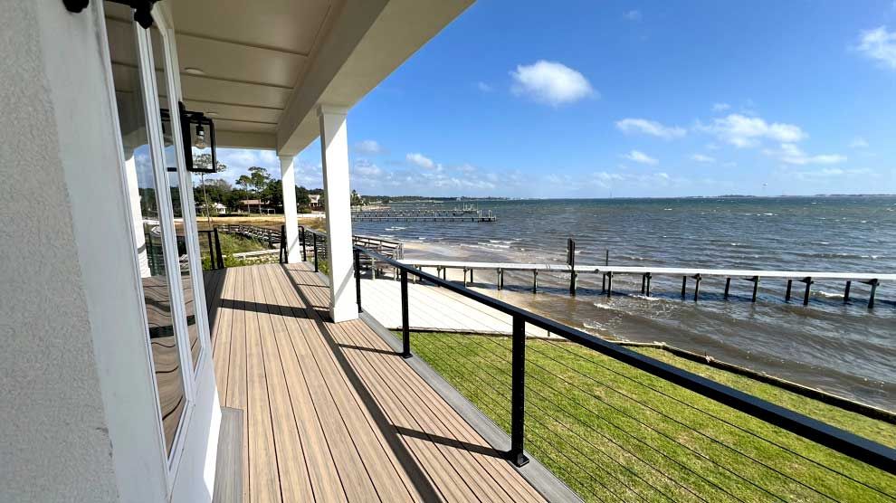 A house with a balcony and a table and chairs on it