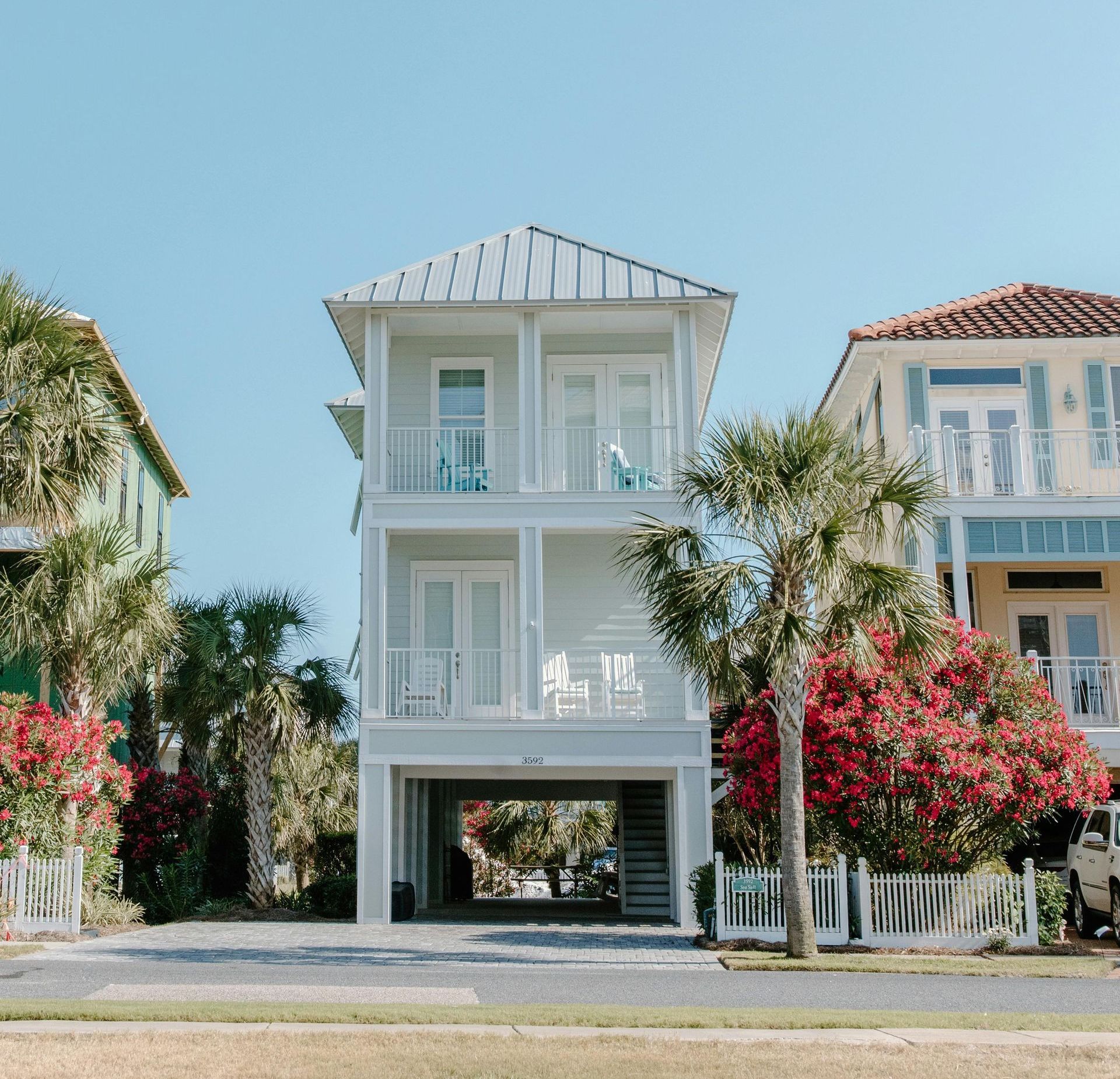 A row of houses with red flowers in front of them