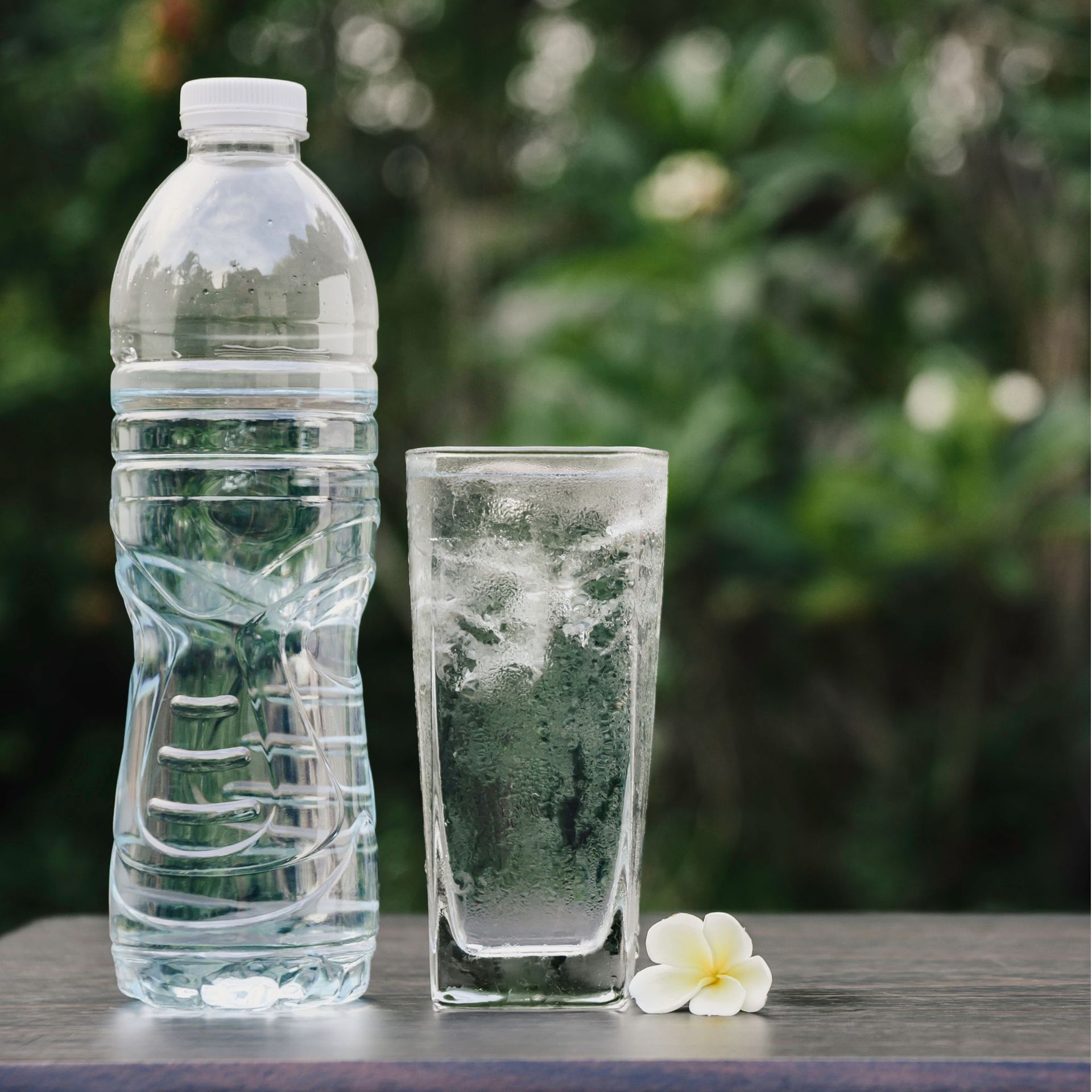 Tetra Water - A bottle of water and a glass of water on a table