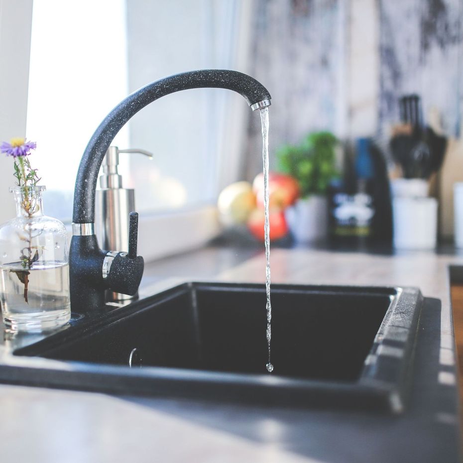 Tetra Water - A kitchen sink with water running from the faucet