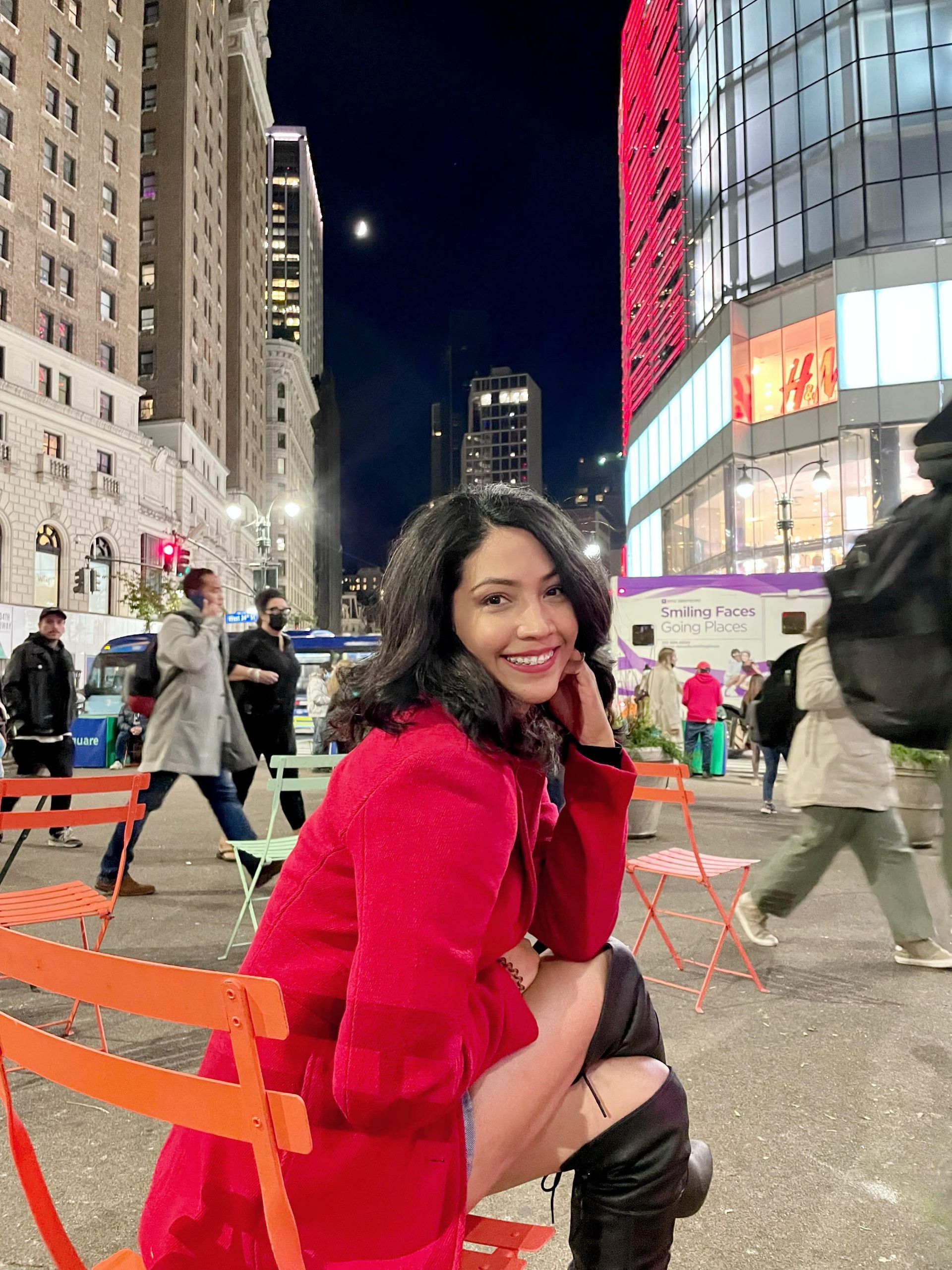 Blond man smiling, head and shoulders shot, black shirt, against a textured gray background.