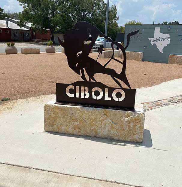 A statue of a bull with the word cibolo on it