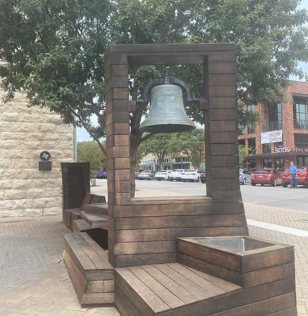 A wooden structure with a bell on top of it