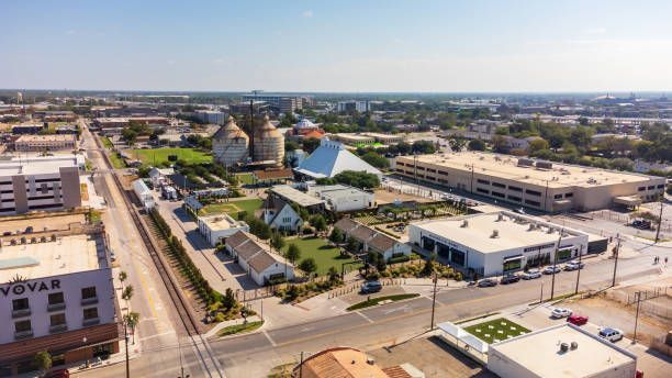An aerial view of a city with a hot air balloon in the distance.