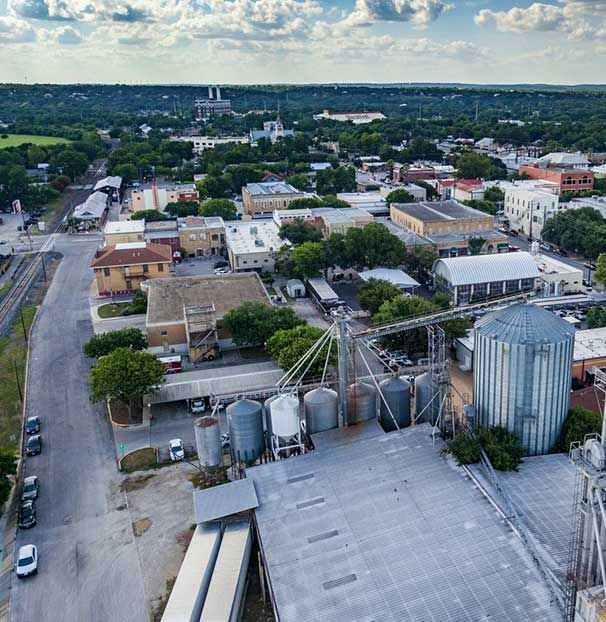 An aerial view of a city with silos and buildings