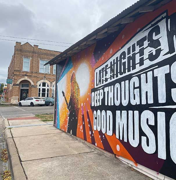A mural on the side of a building that says life nights deep thoughts good music