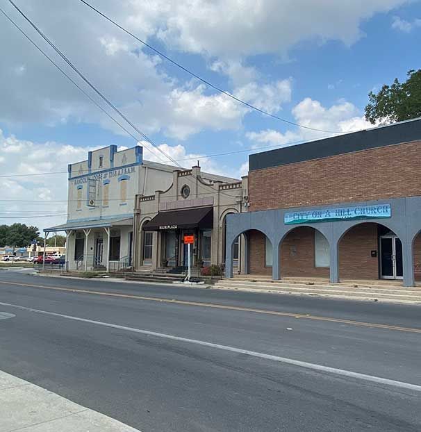 A row of buildings on the side of a road