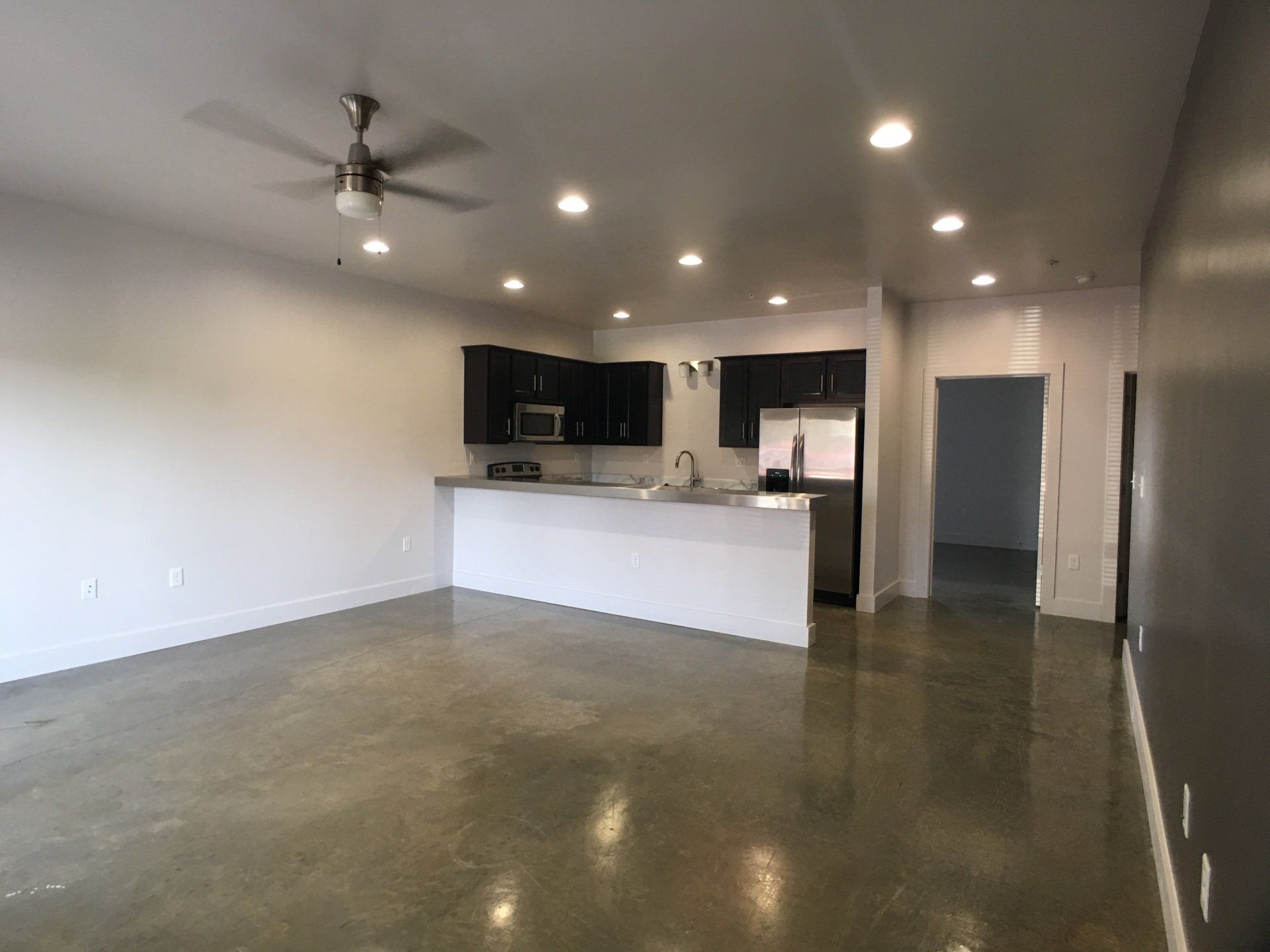 A large living room with modern kitchen
