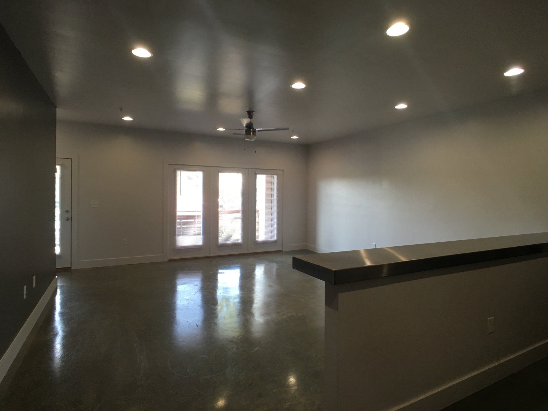 A large living room with glass doors to a balcony