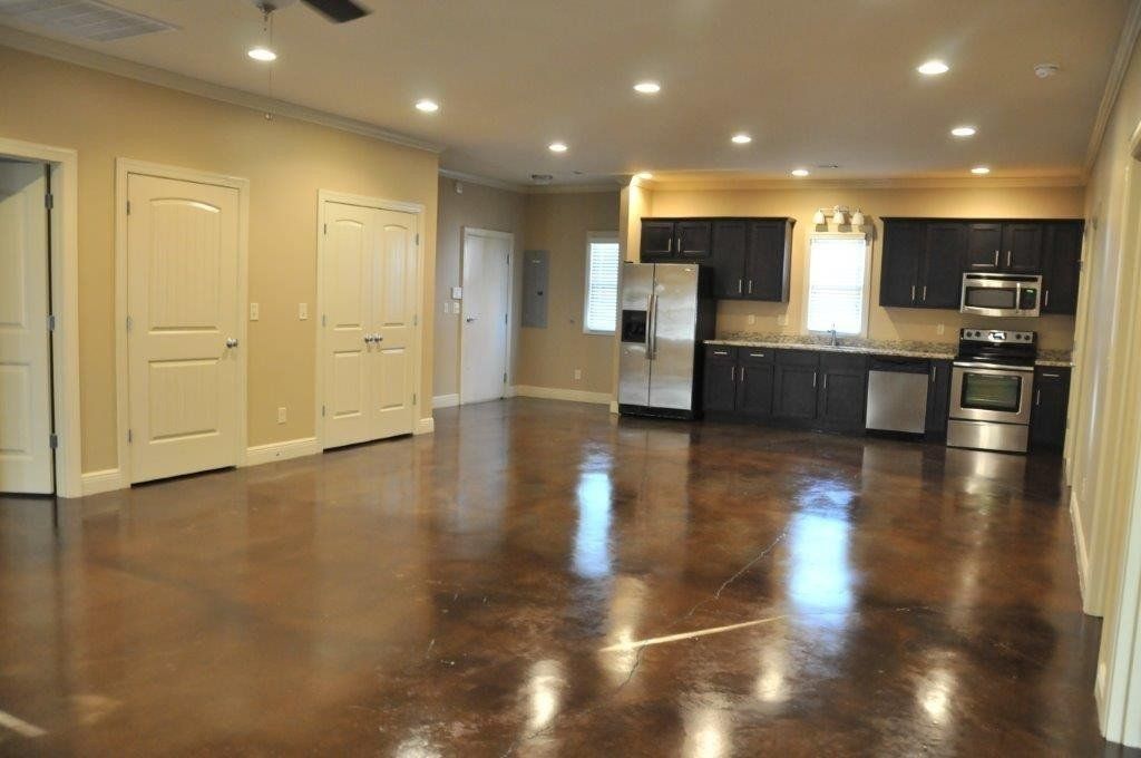 A large kitchen and dining area with storage closets and stainless steel appliances