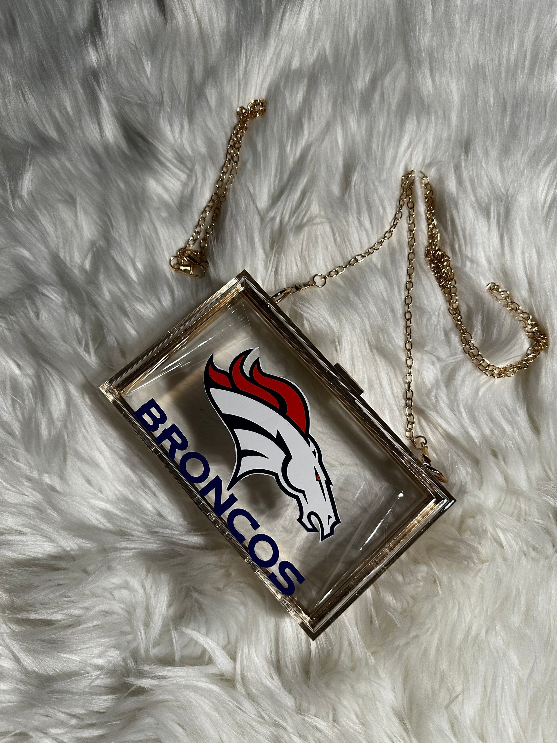 A clear purse with a broncos logo on it