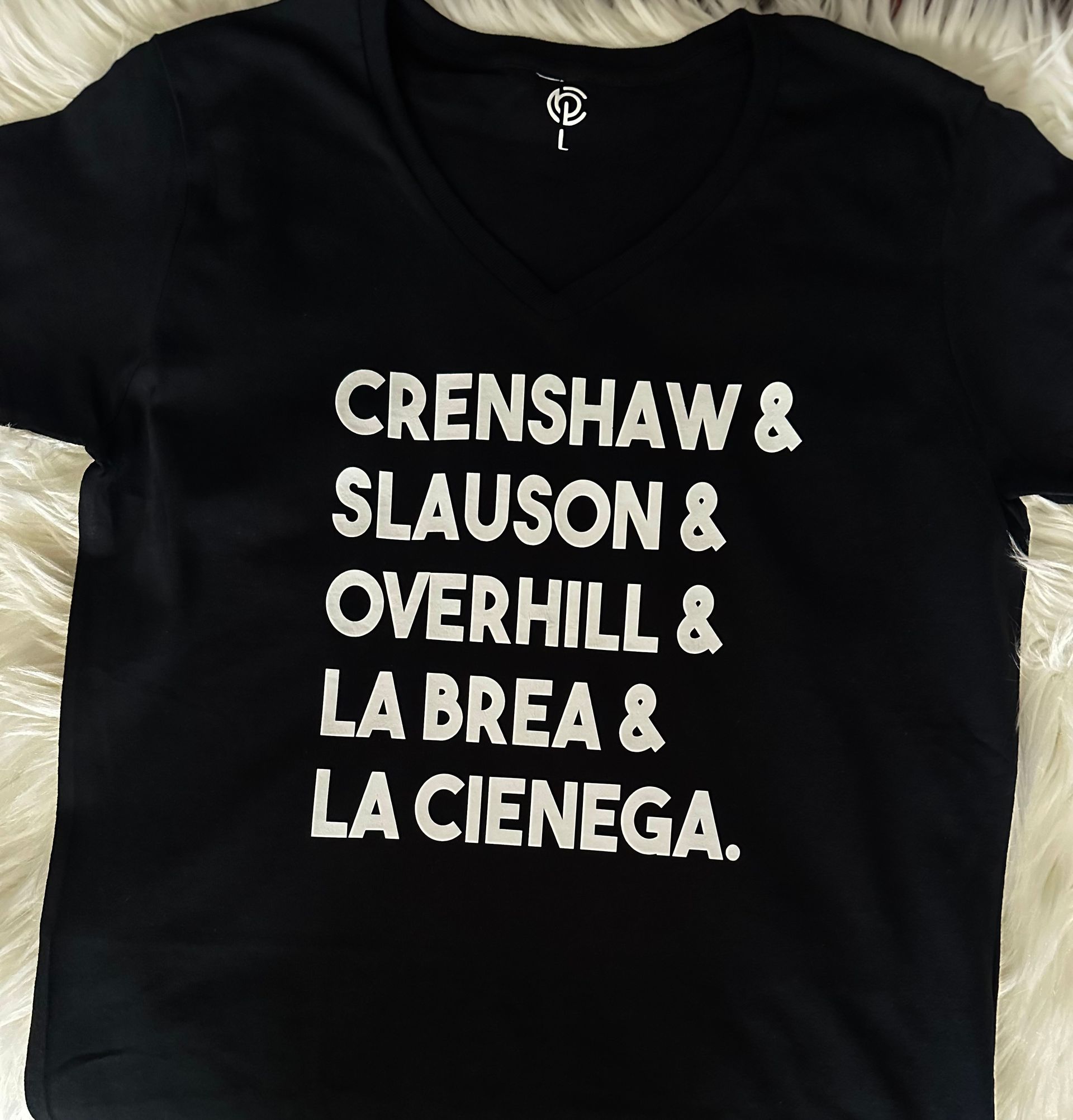 A black shirt that says crenshaw & slauson & overhill & la brea & la cienega