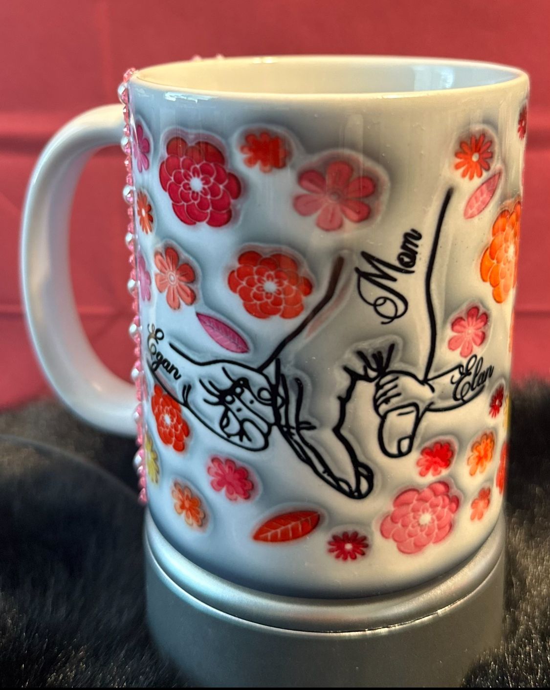 A coffee mug with children holding moms hand with children's names