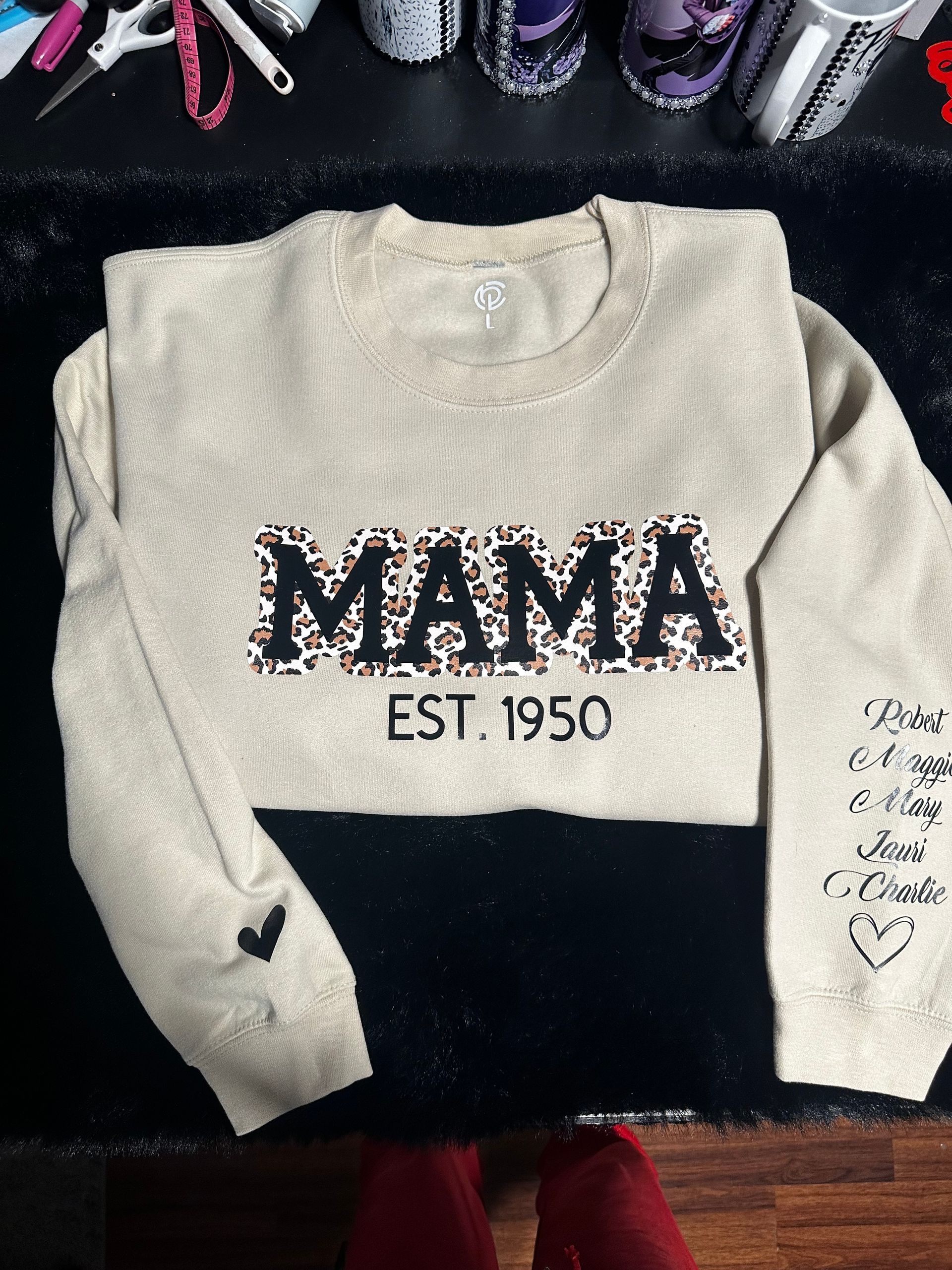 A sweatshirt that says mama est 1950 on it