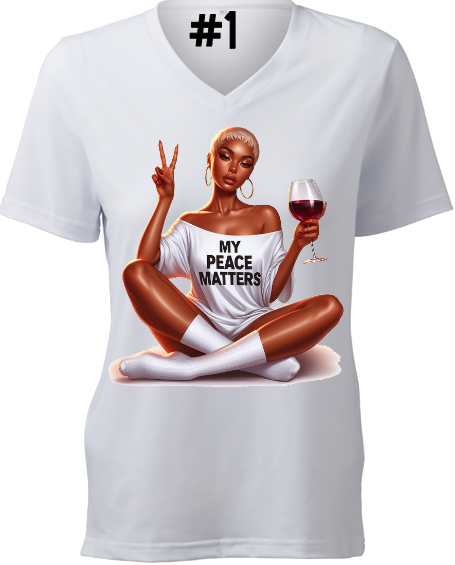 A woman is sitting on the floor holding a glass of wine and a peace sign.