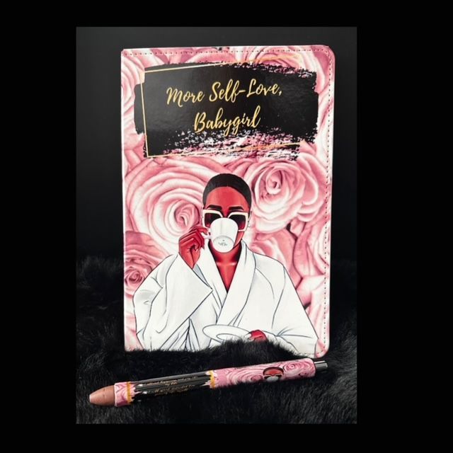 A notebook with a pen that says more self love babygirl
