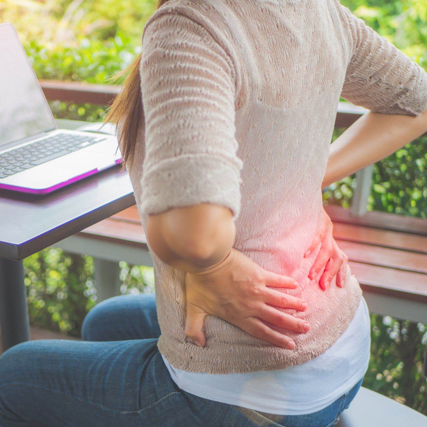 Woman Holding Her Waist Back in Pain — Dodge City, KS — Phillips Chiropractic & Physical Therapy Center