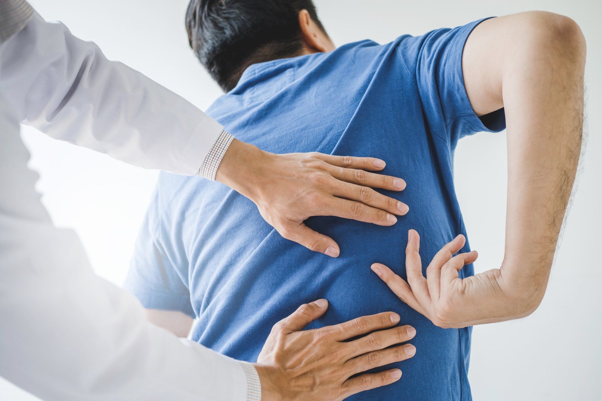 Chiropractor — Physical Doctor With Patient Having Back Problems in Dodge City, KS