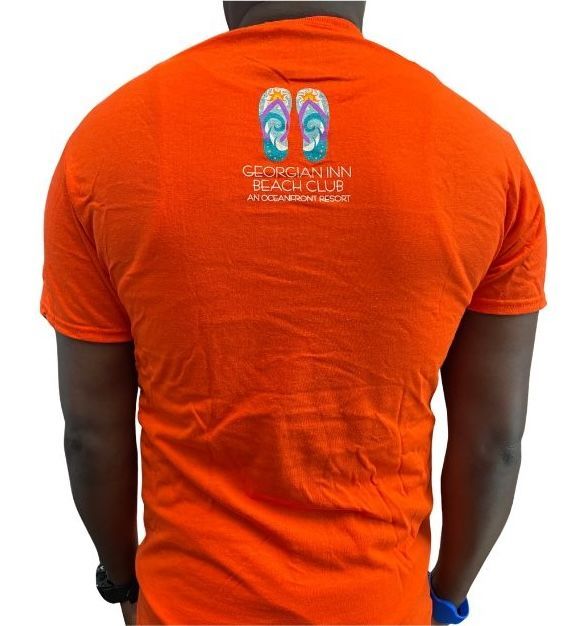 Orange t-shirt with flip-flop design and text, viewed from the back, on a person.