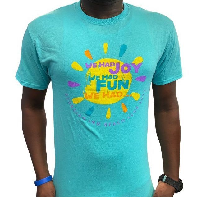 Turquoise t-shirt with a colorful sun graphic and text: 