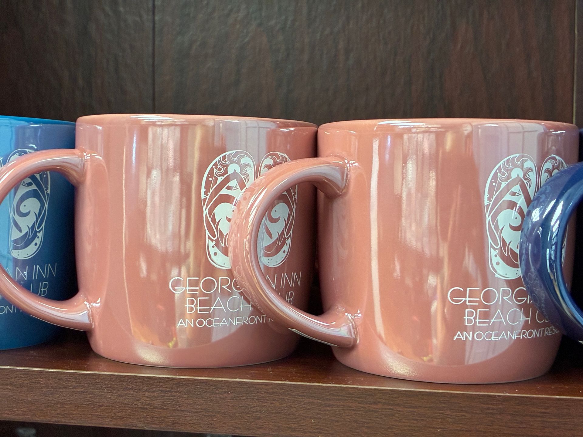 Pink mugs with a white design and 