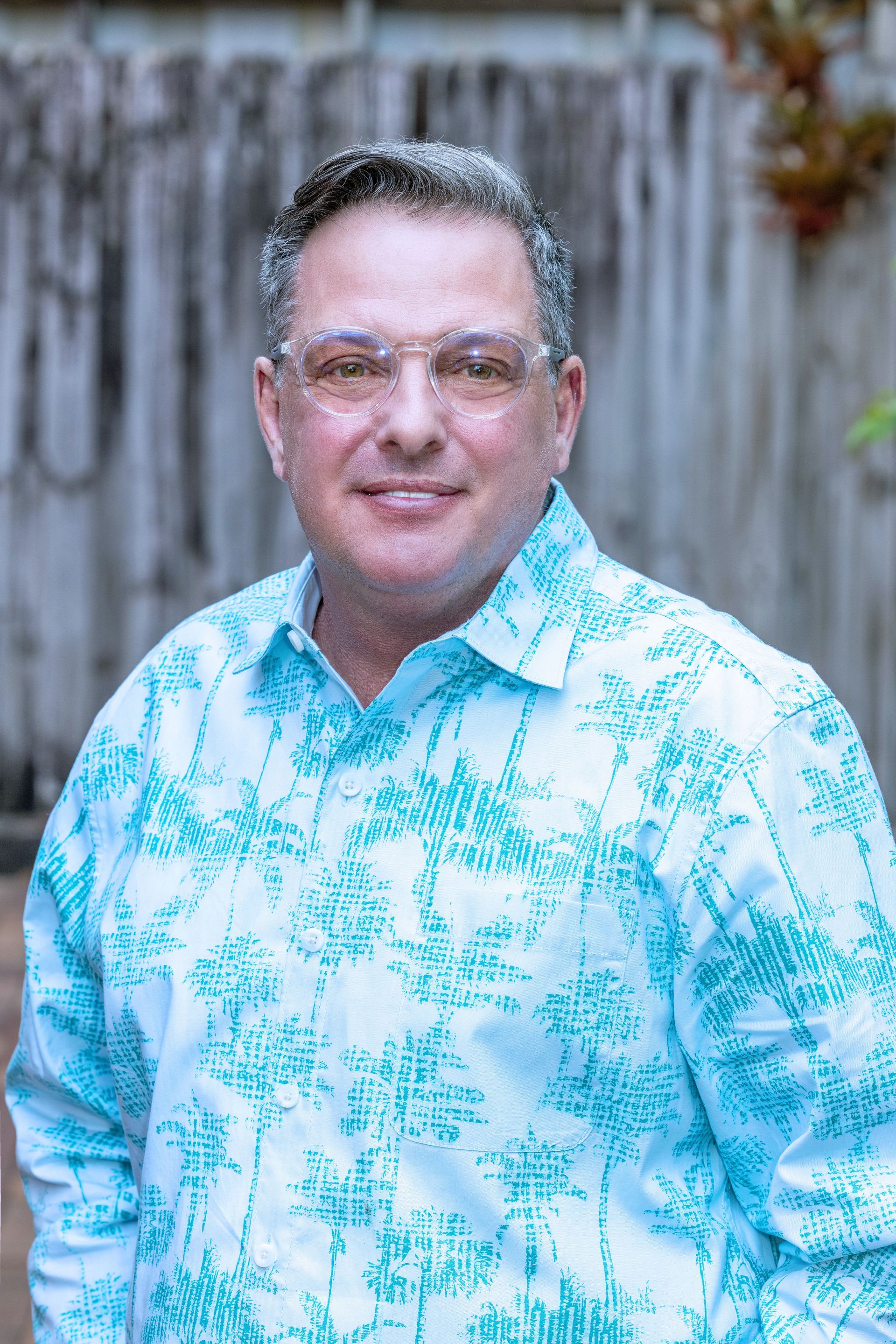 Man in blue shirt, holding hands with doctor in white coat, offering support.