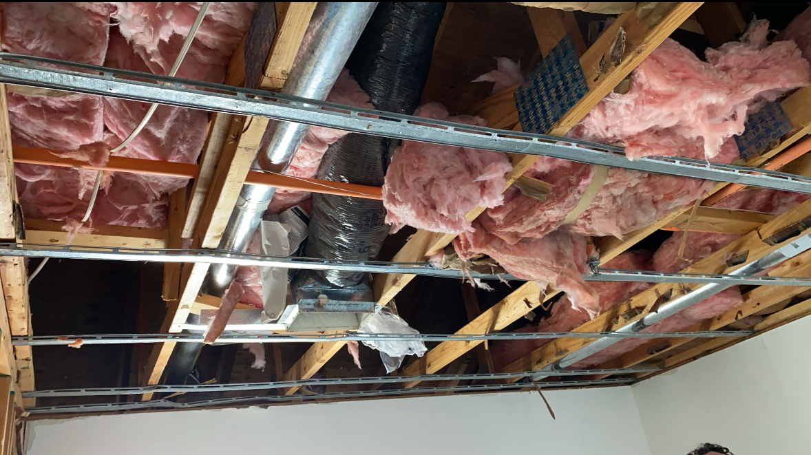 A kitchen in an abandoned house with a stove and refrigerator