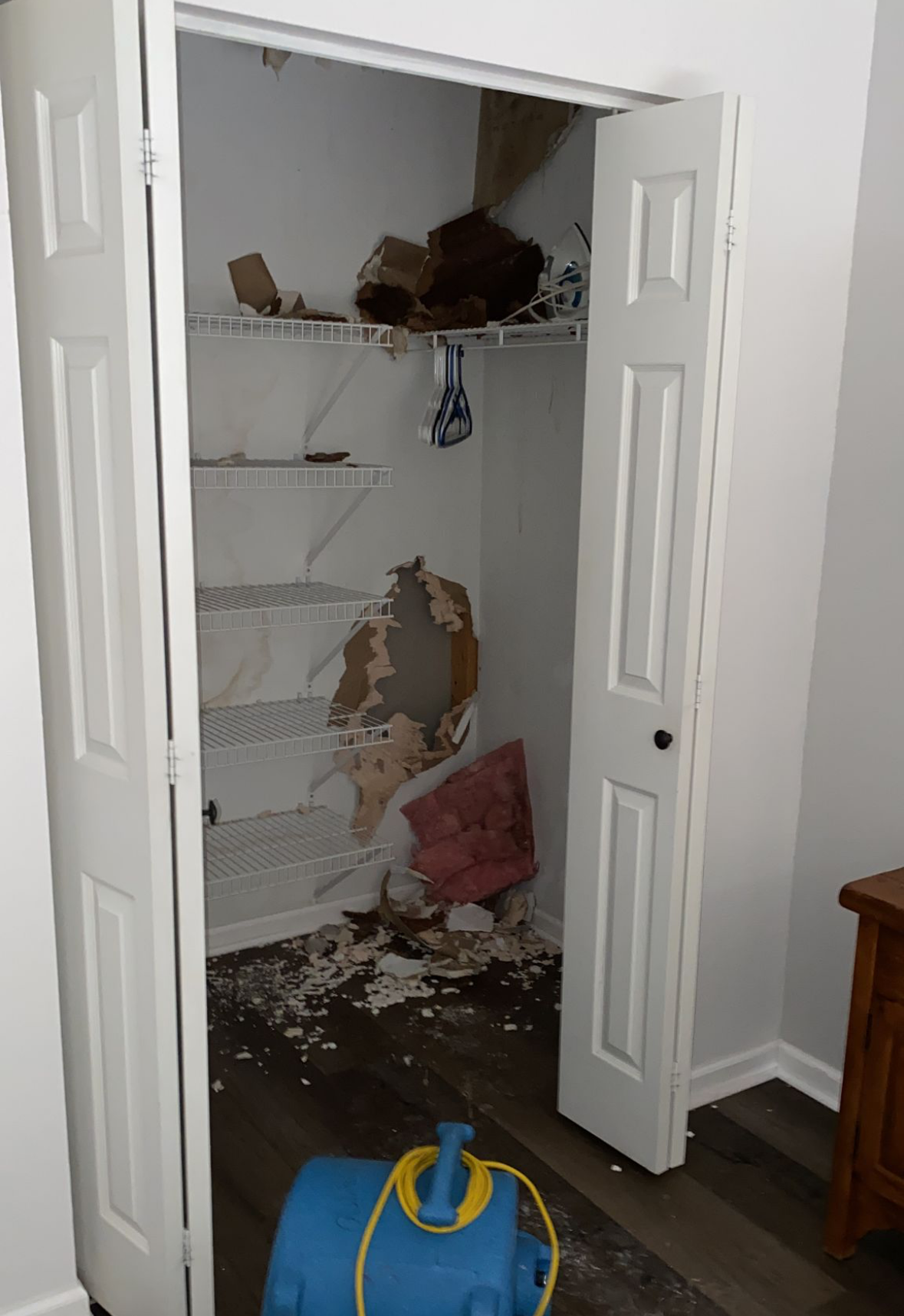 A ceiling with water coming out of it and a light on it.