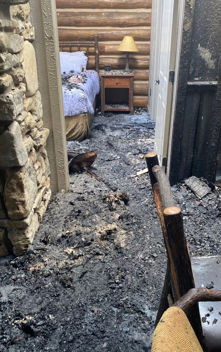 An empty room in an abandoned building with a green door.