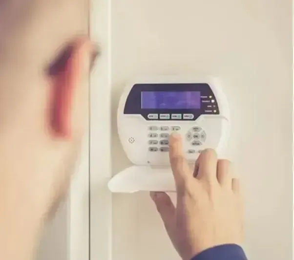 Man Operating Security Alarm — Security Systems in Townsville