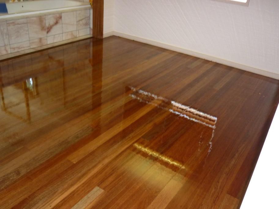 A Bathroom With A Wooden Floor And A Bathtub — AJ's Cleaning & Floor Sanding In Woree, QLD