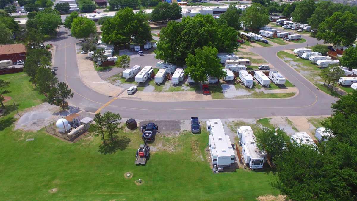 An aerial view of a rv park with a lot of rvs parked in a lot.