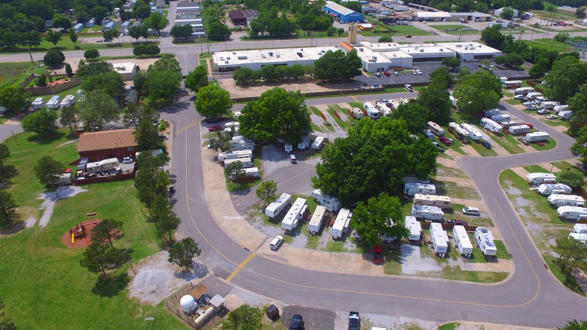 An aerial view of a park with a lot of rvs parked in it.