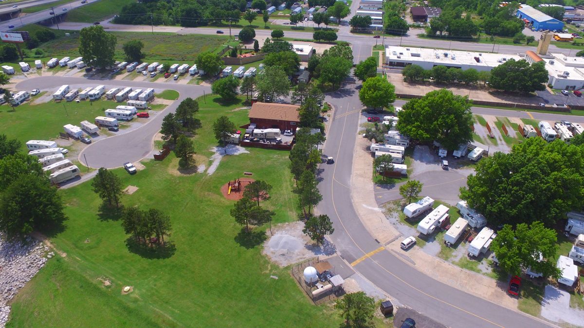 An aerial view of a park with a lot of rvs parked in it.