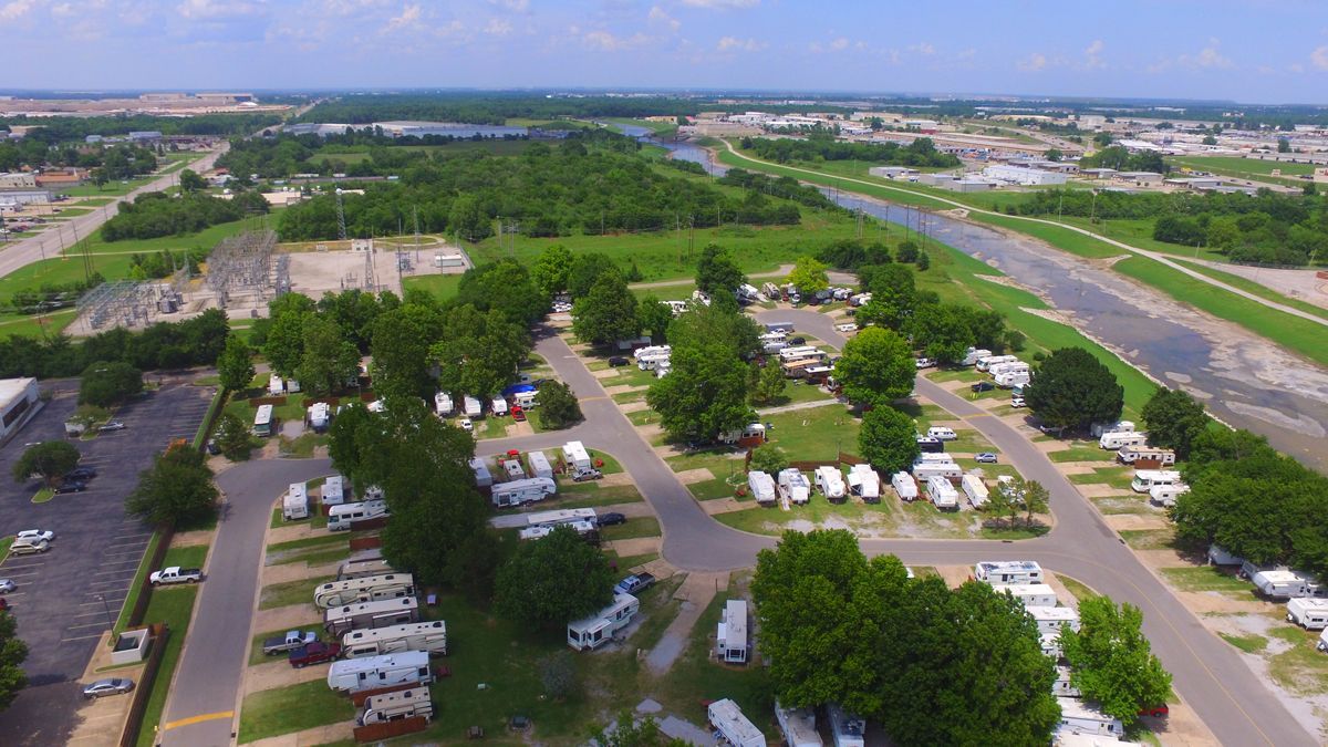 An aerial view of a campground with a river in the background.